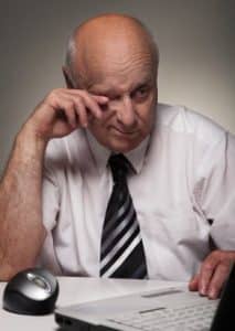 Tired desk worker who most likely suffers from insomnia